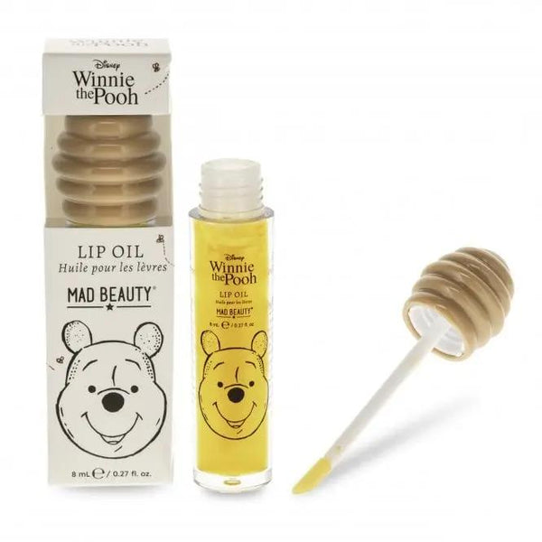 Mad Beauty Winnie The Pooh Lip Oil, een hydraterende lipolie met honinggeur en bijenkorfvormige dop.